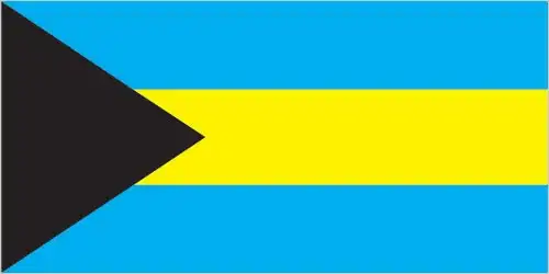 The Bahamian flag features a black equilateral triangle at the hoist, pointing toward three horizontal stripes—in aquamarine, gold, and aquamarine. Adopted in the national flag contest as independence was declared on July 10, 1973, it was hoisted at midnight to mark the birth of the new nation.