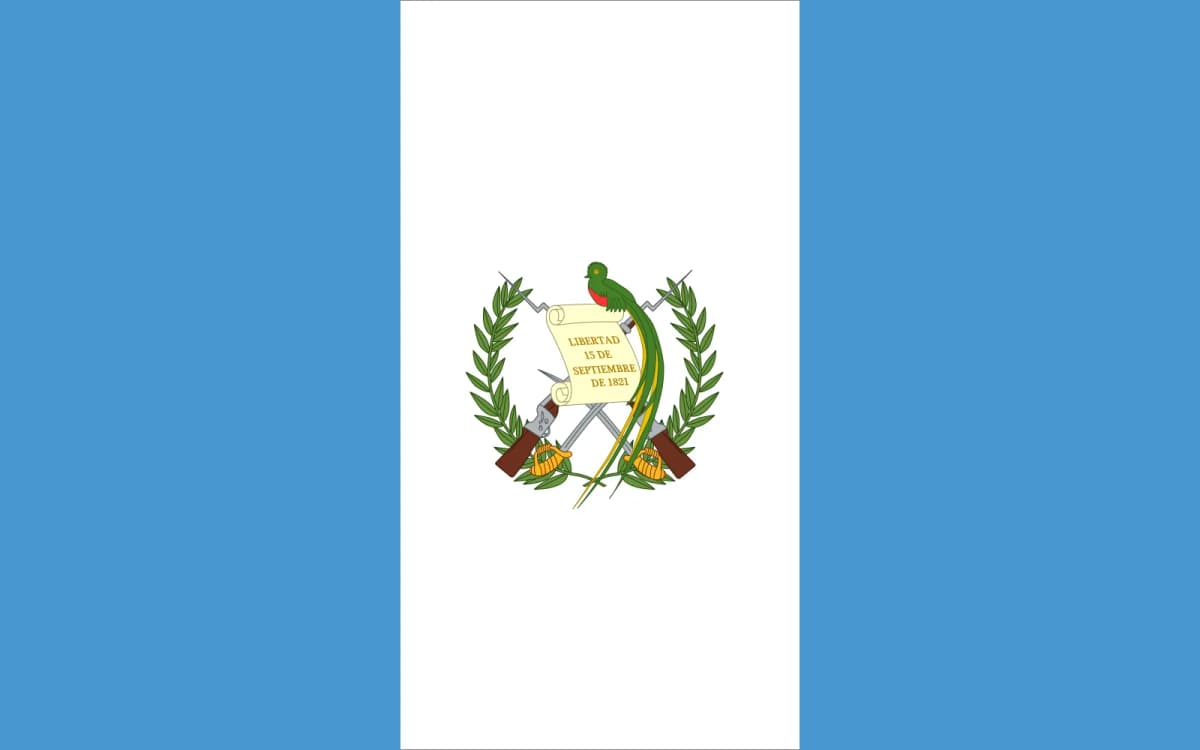 The flag of Guatemala consists of three vertical bands: two sky-blue outer panels flanking a white panel bearing the national emblem. The design reflects ideals of sovereignty, peace, and the nation’s ties to both the Pacific and Atlantic oceans.